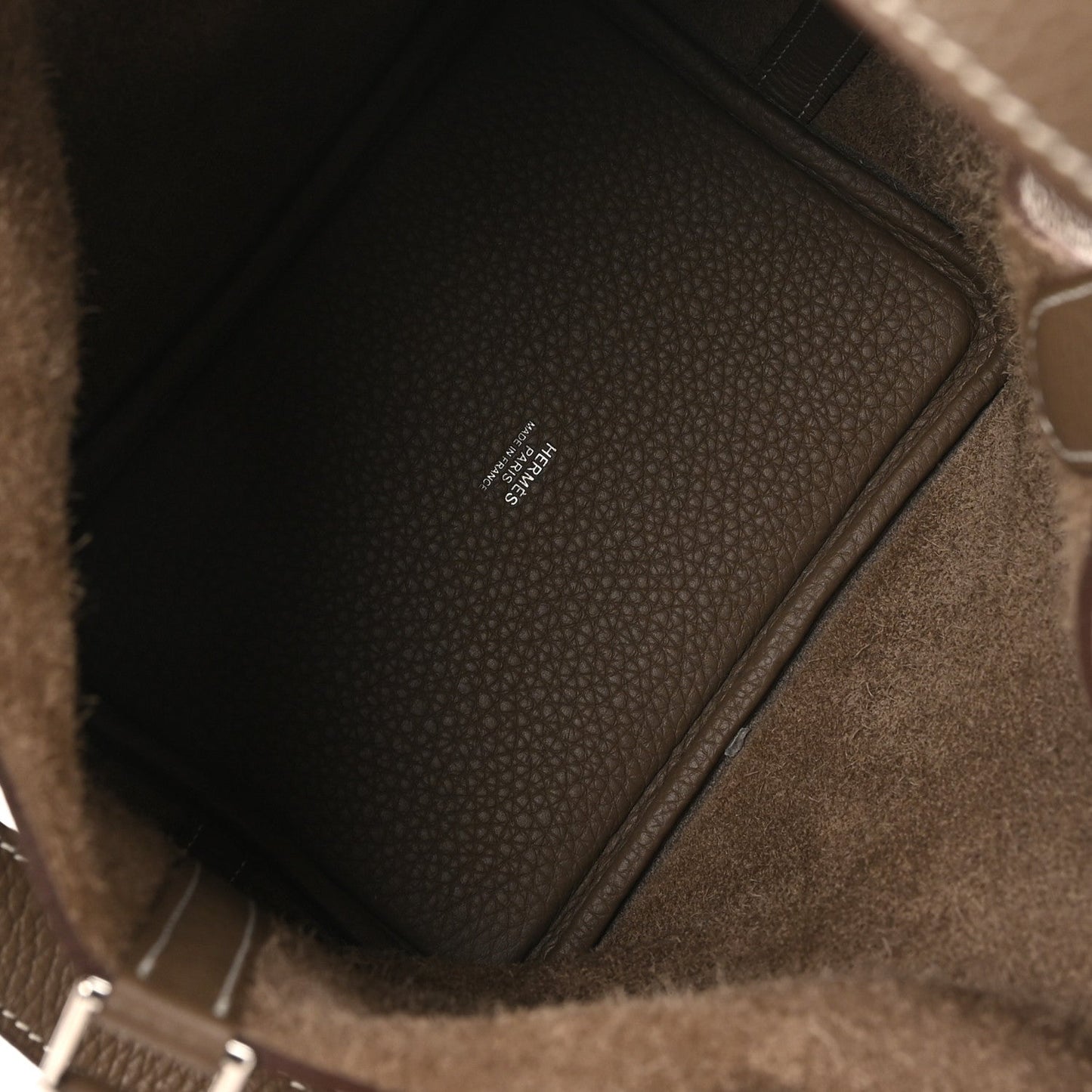 Tote bag interior with pebbled leather texture and stitched edge