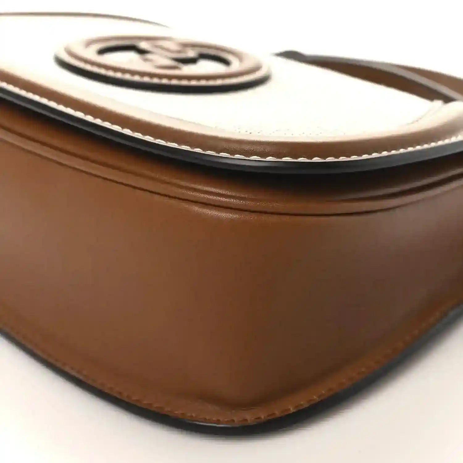 Brown leather top edge with beige canvas trim and stitched border