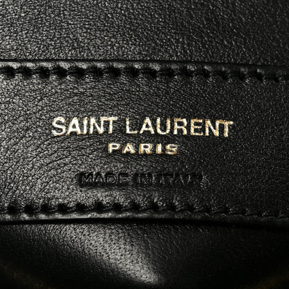 SAINT LAURENT PARIS and MADE IN ITALY text on black leather patch with stitching.
