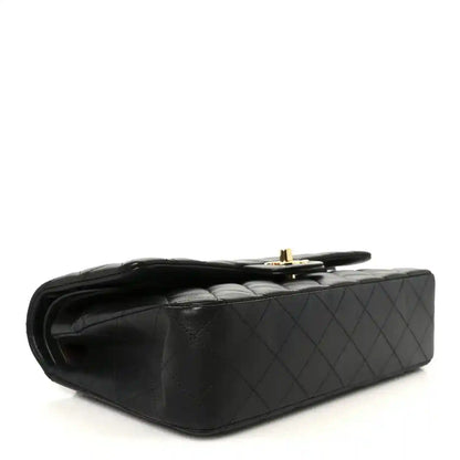 Chanel black quilted lambskin double flap bag, side view with gold hardware