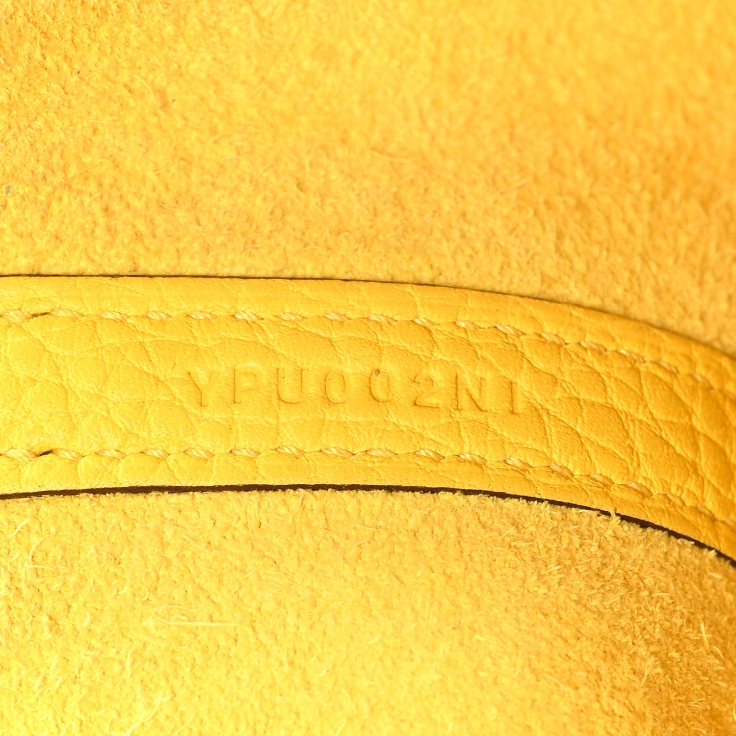 Lime yellow leather with embossed lettering along curved edge