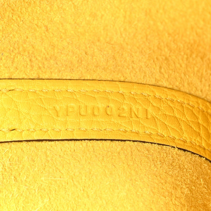Lime yellow leather with embossed lettering along curved edge