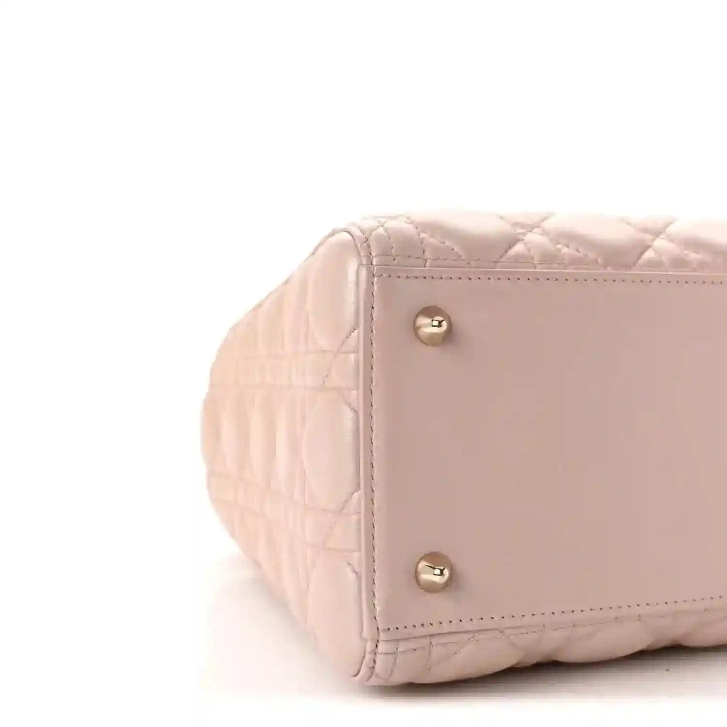Light pink quilted handbag side with two gold studs and stitched panel detail