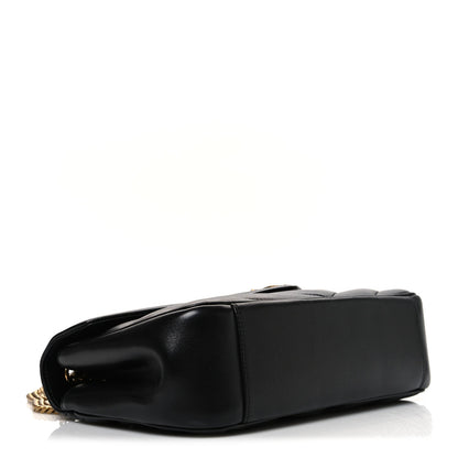 Black quilted lambskin shoulder bag with rounded flap and gold chain strap