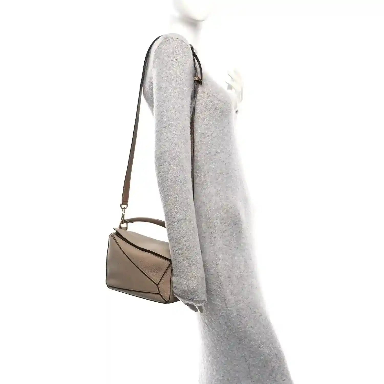 Small Puzzle bag side view with adjustable strap, grained sand leather