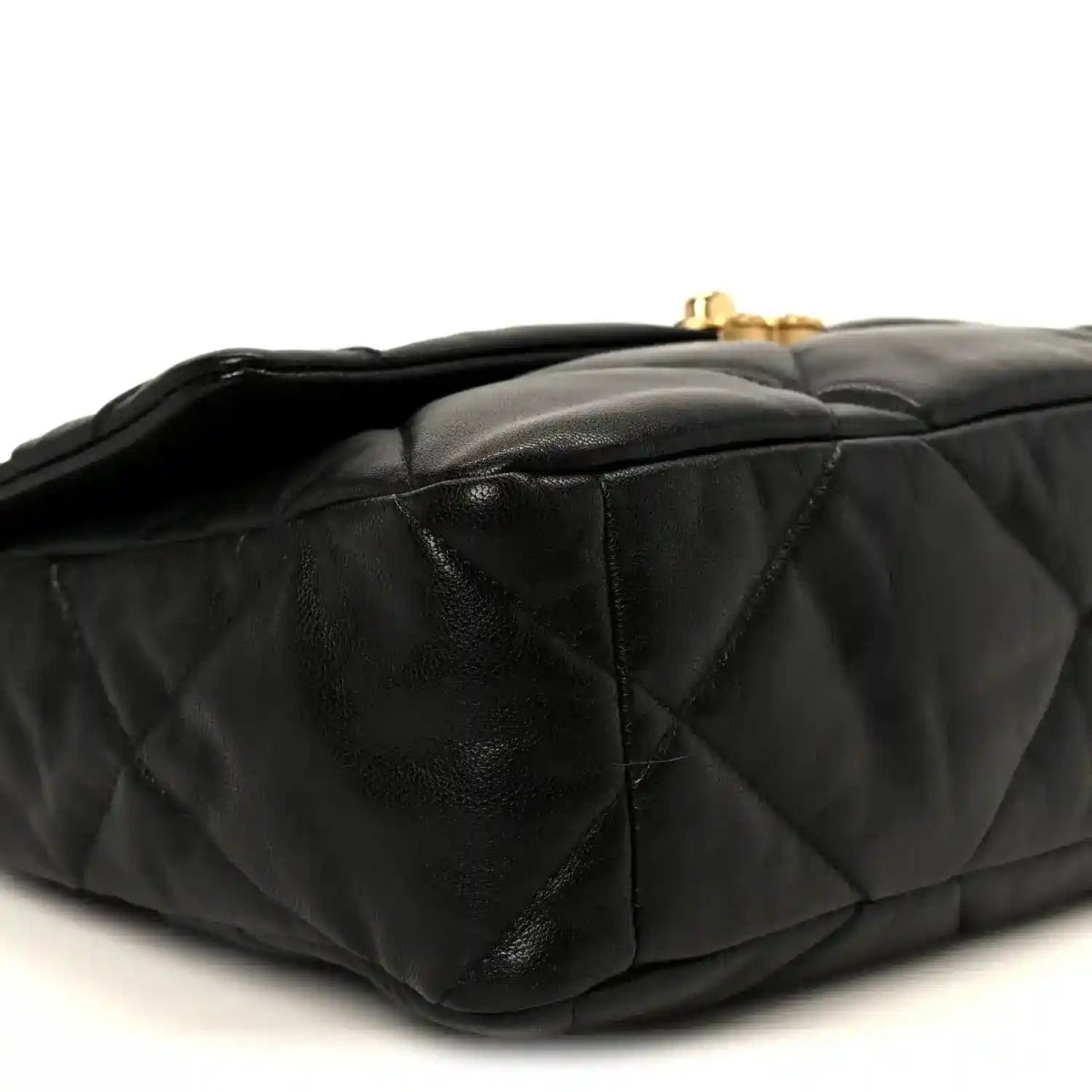 Black quilted leather flap bag side view with turn-lock hardware