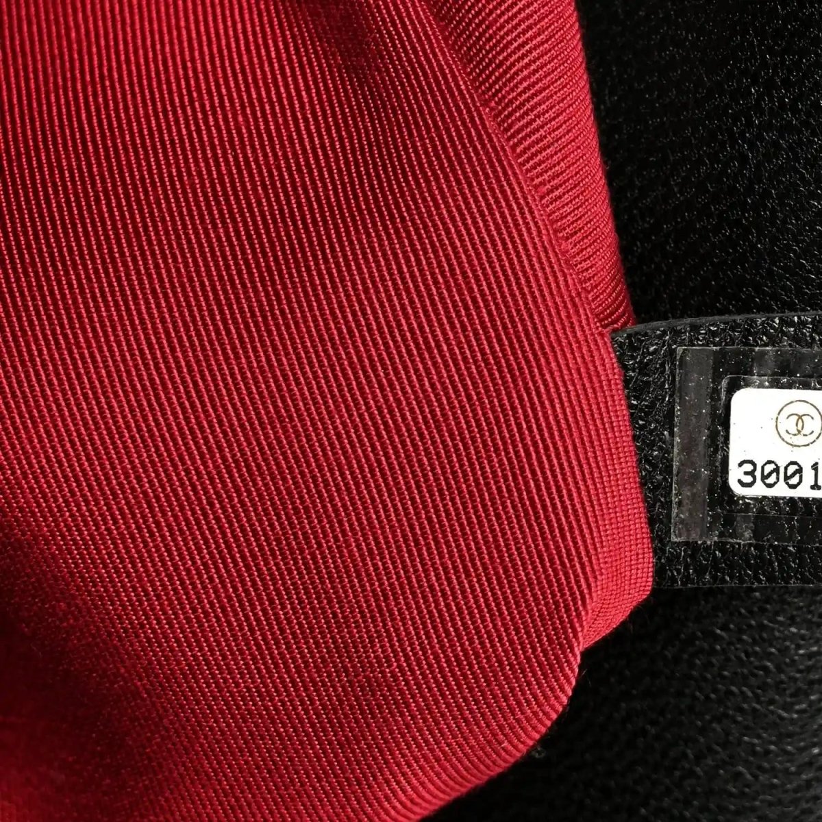 Red fabric lining with black interior tag and Chanel logo seal