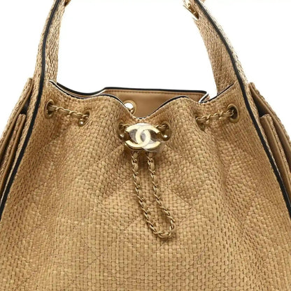 Beige braided raffia handbag top with CC logo charm and chain shoulder straps