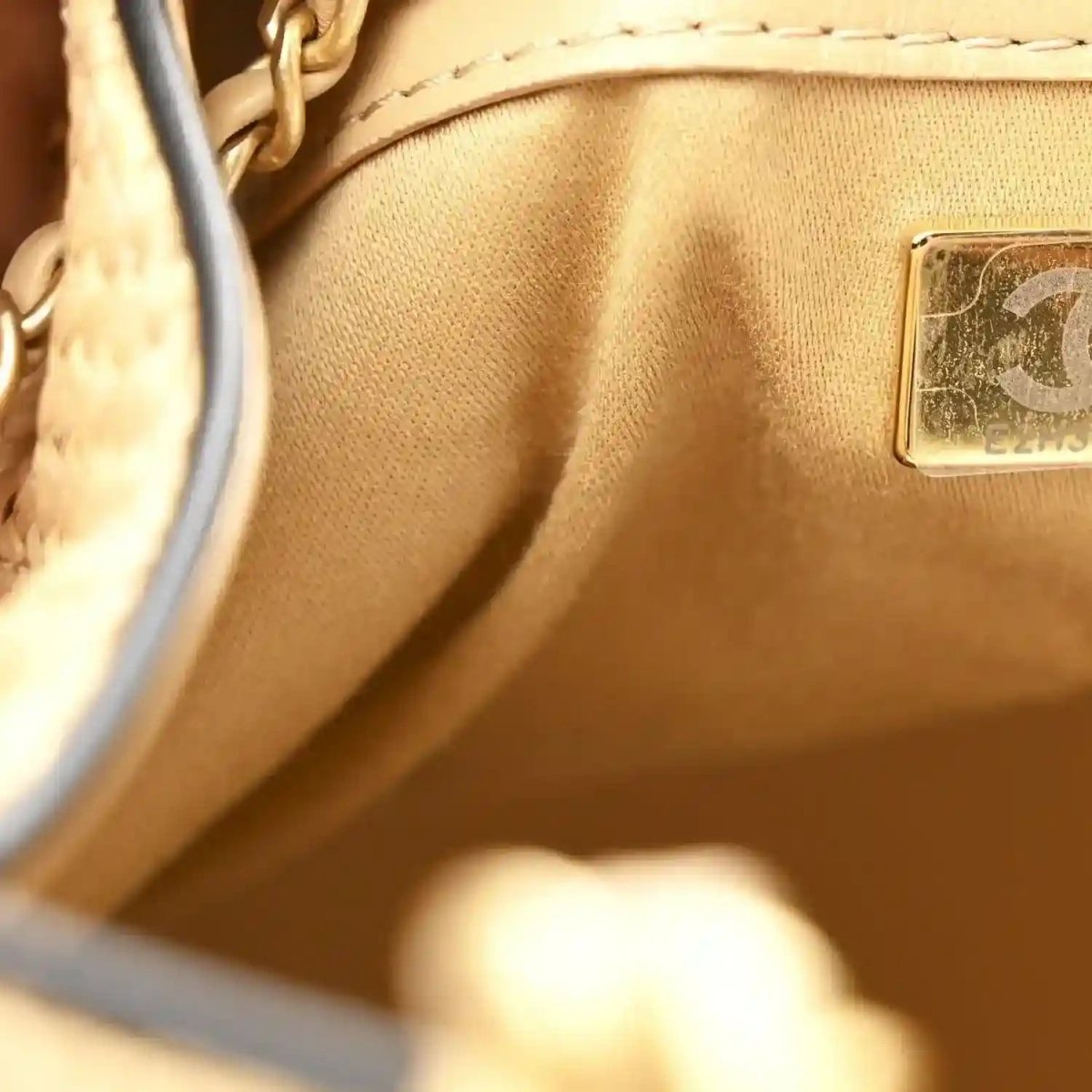 Beige raffia handbag interior with leather tag and small logo patch