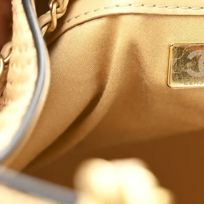 Beige raffia handbag interior with leather tag and small logo patch