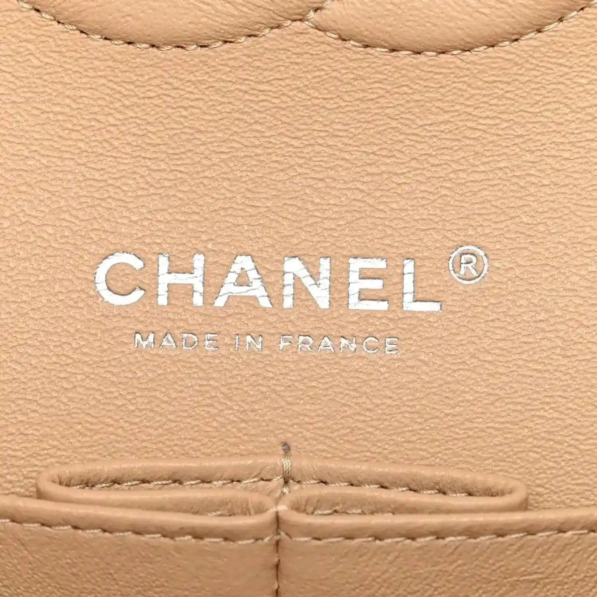 Chanel logo patch on beige leather caviar bag with “MADE IN FRANCE” text