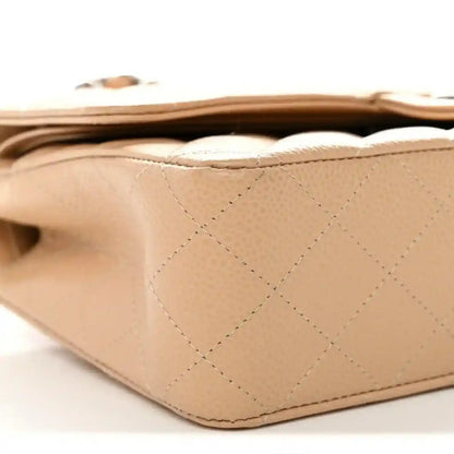 Chanel beige quilted caviar bag bottom edge with stitching and flap overlap