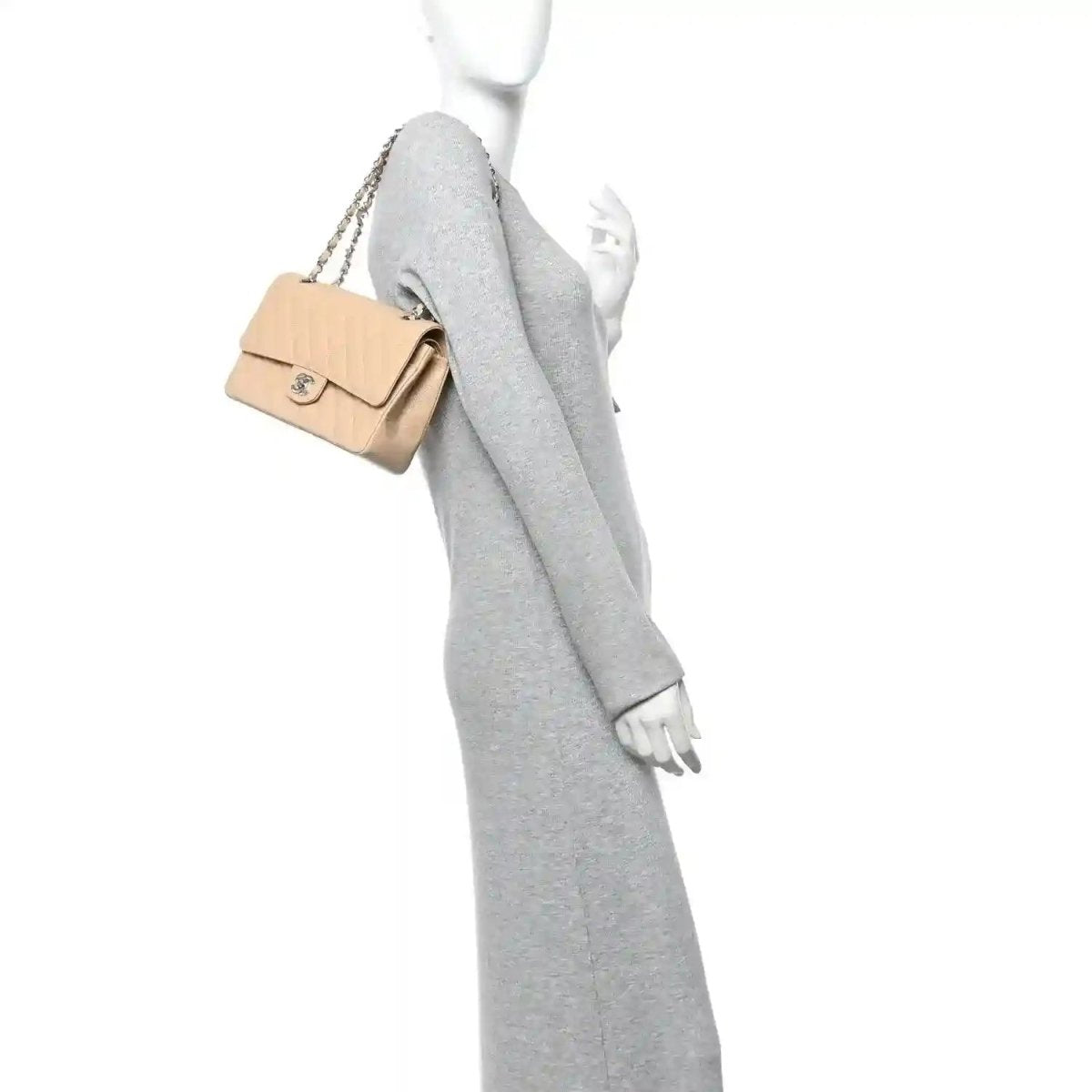 Chanel beige quilted caviar shoulder bag with chain strap, shown on a model