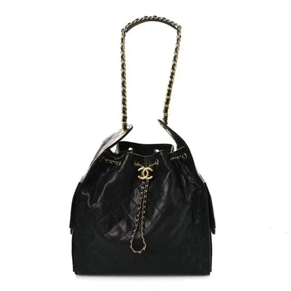 Black quilted leather handbag with chain top handle and drawstring opening