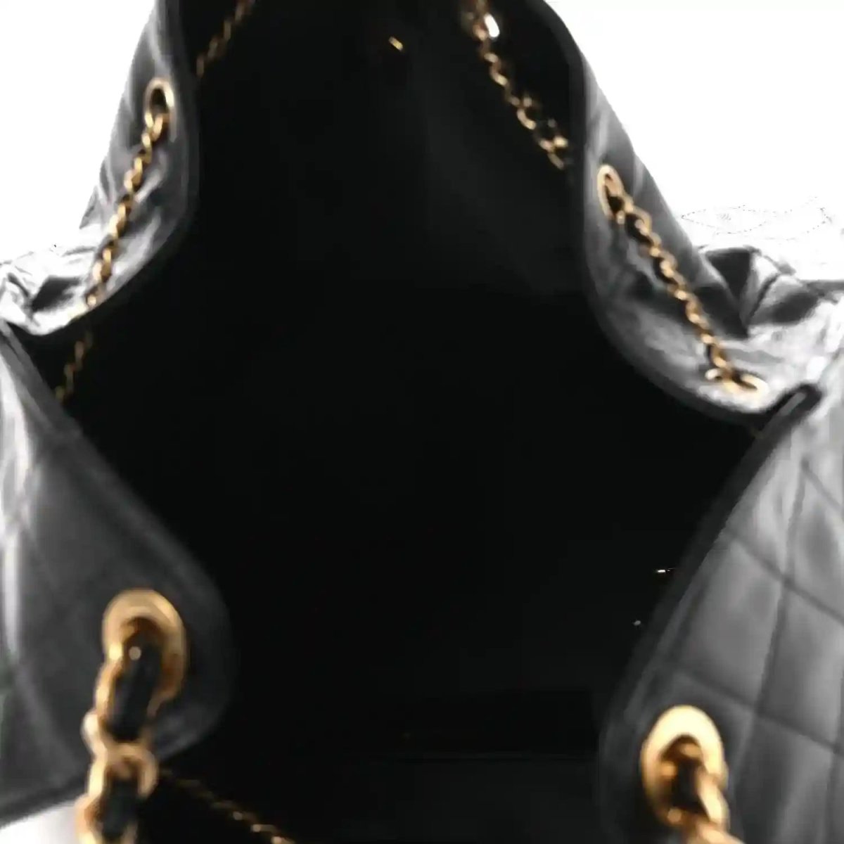 Black quilted leather handbag interior with gold-toned chain and hardware
