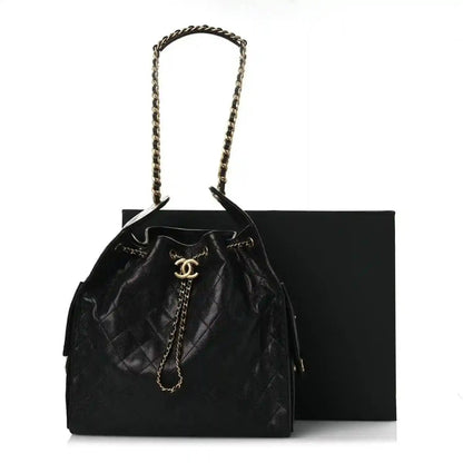 Black quilted leather drawstring handbag with chain shoulder strap and Chanel CC emblem