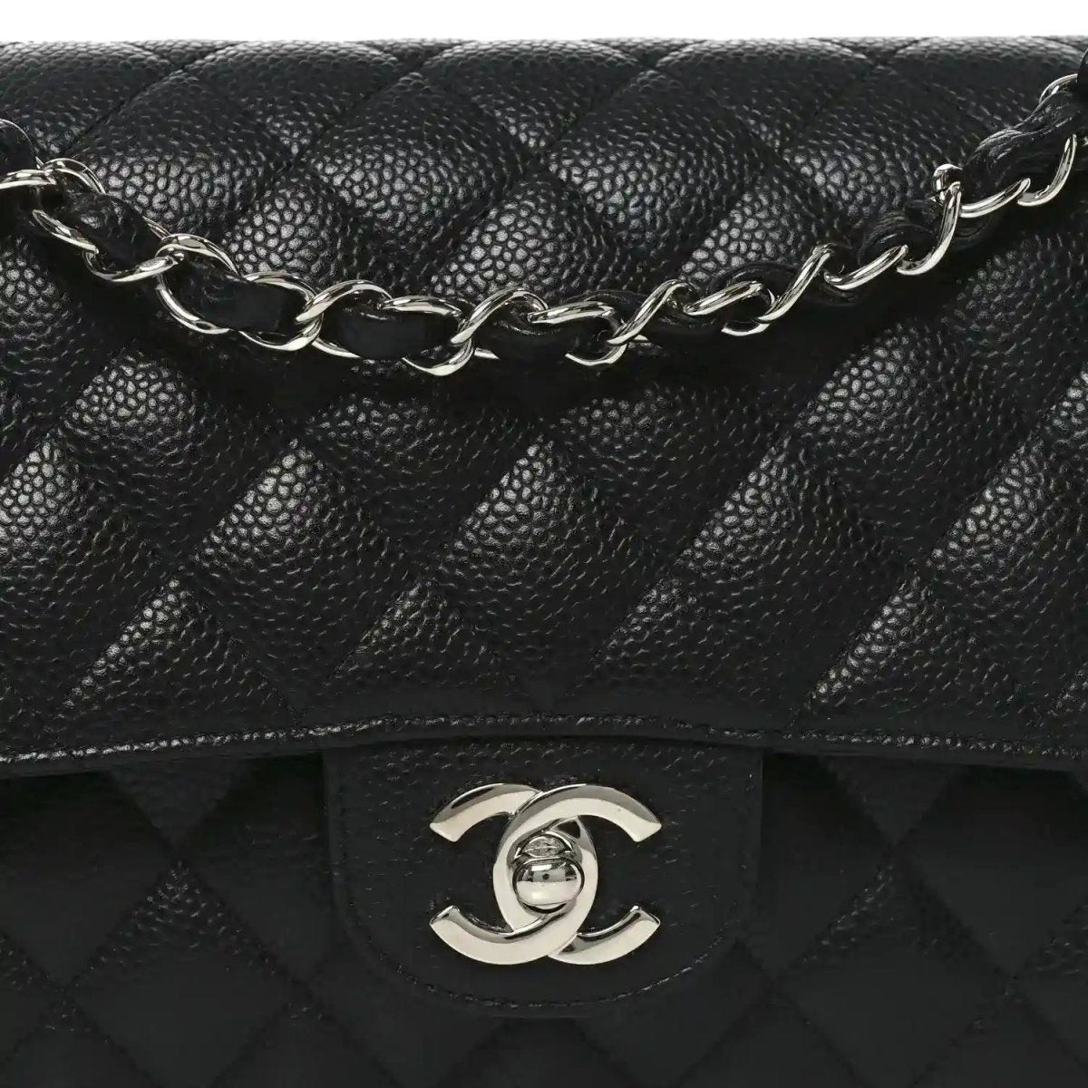 Black quilted leather flap bag with silver-tone chain strap and Chanel CC clasp