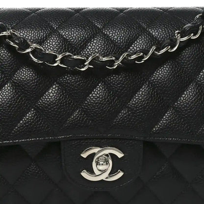 Black quilted leather flap bag with silver-tone chain strap and Chanel CC clasp