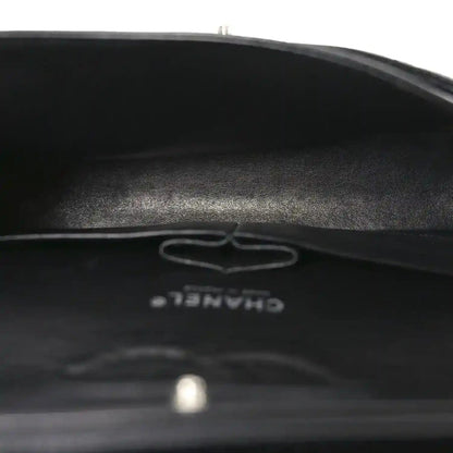 Black leather interior base with embossed Chanel logo and serial mark