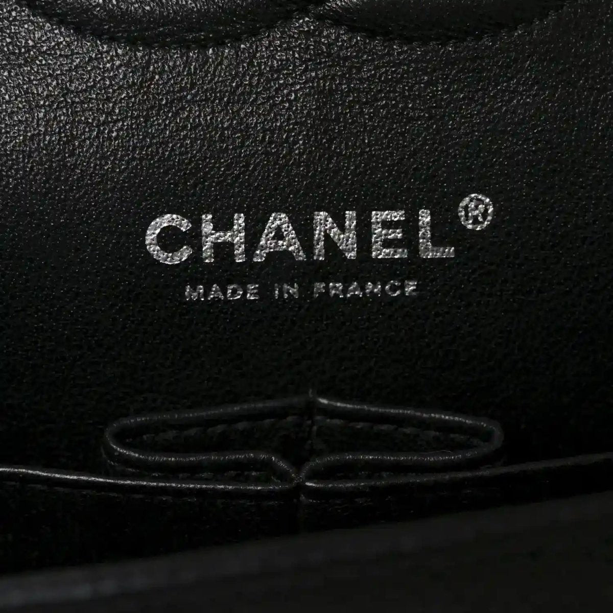 Black caviar leather interior stamp reading CHANEL and MADE IN FRANCE