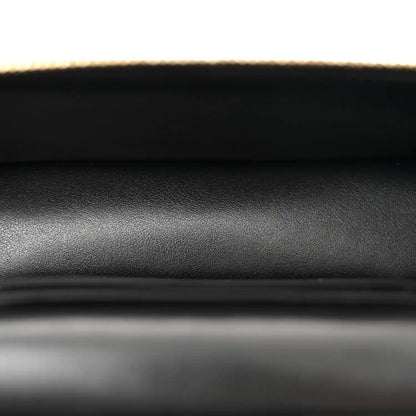 Black quilted leather with fine pebble texture, close-up