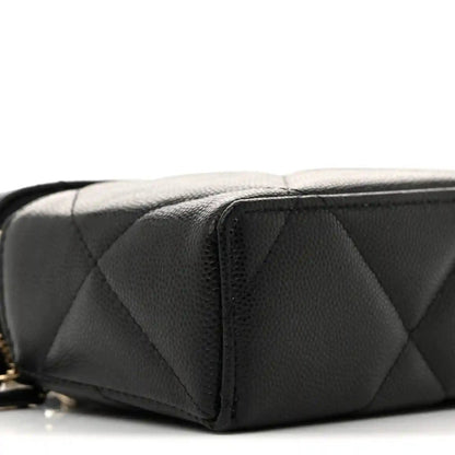 Black quilted leather slim vanity bag side panel with zipper and stitched seams