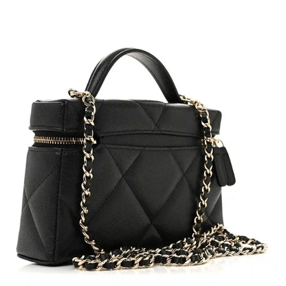 Black quilted leather slim vanity bag with gold chain strap and zipper top