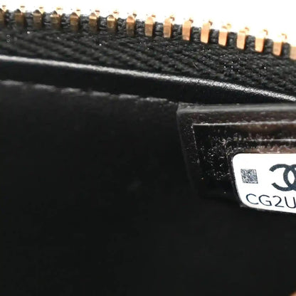 Black leather bag close-up of gold zipper hardware and interior label