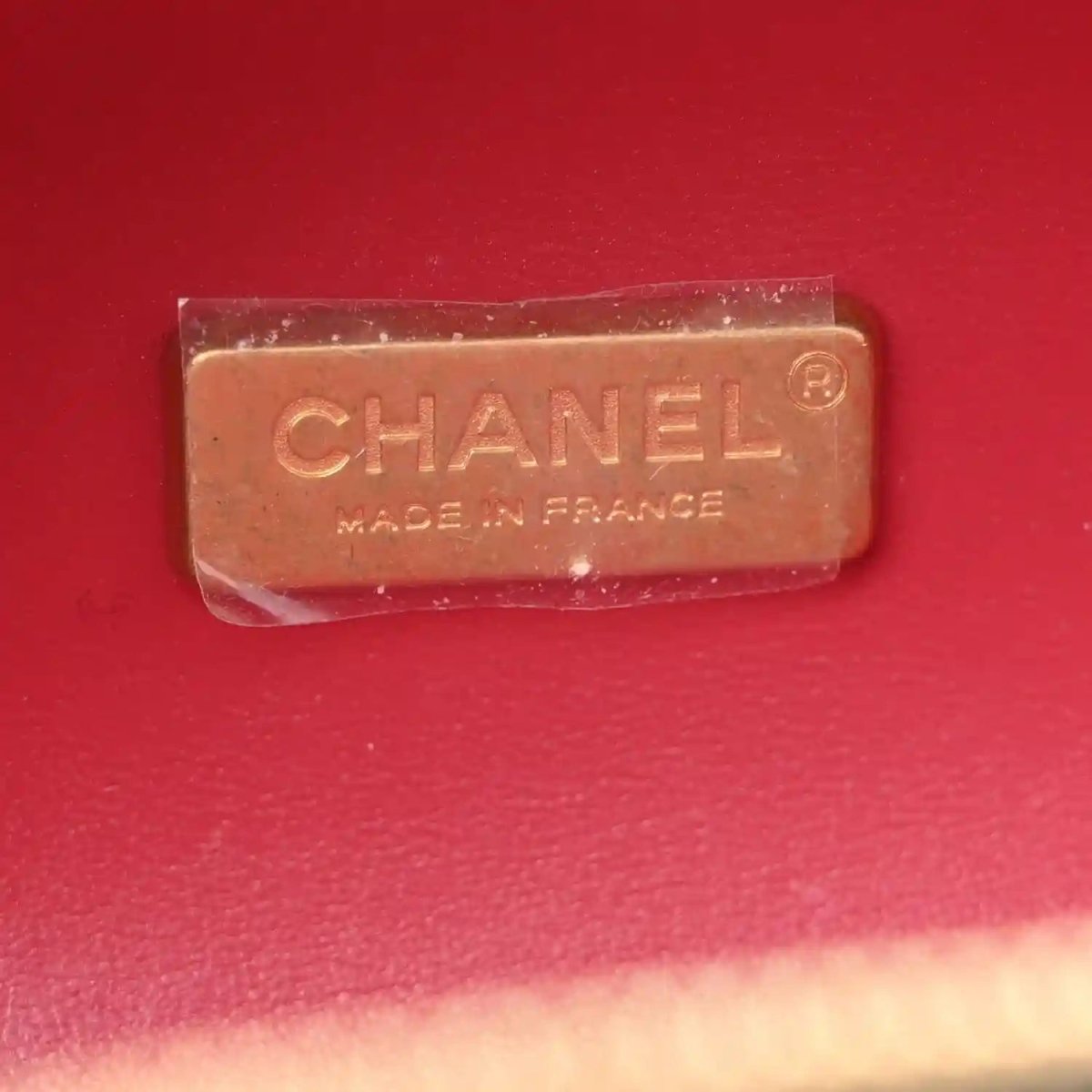 Chanel label reading “MADE IN FRANCE” on red-lined interior