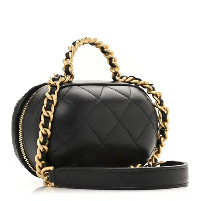 Black quilted vanity chain case with gold zipper and gold chain strap, side view