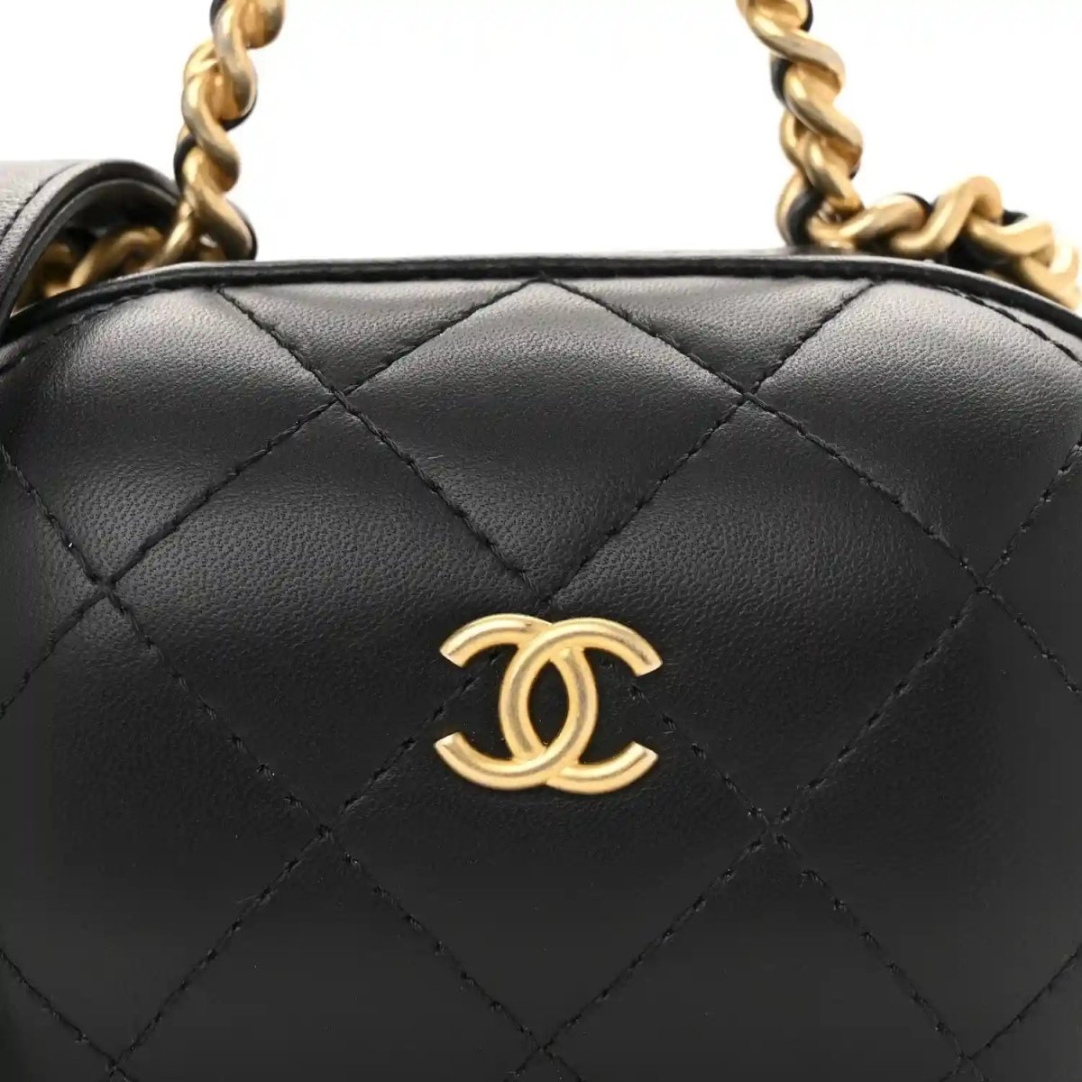 Black quilted vanity case front with gold Chanel CC logo and chain strap