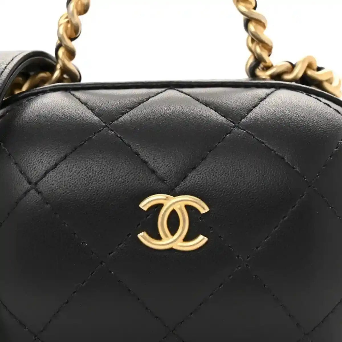 Black quilted vanity case front with gold Chanel CC logo and chain strap