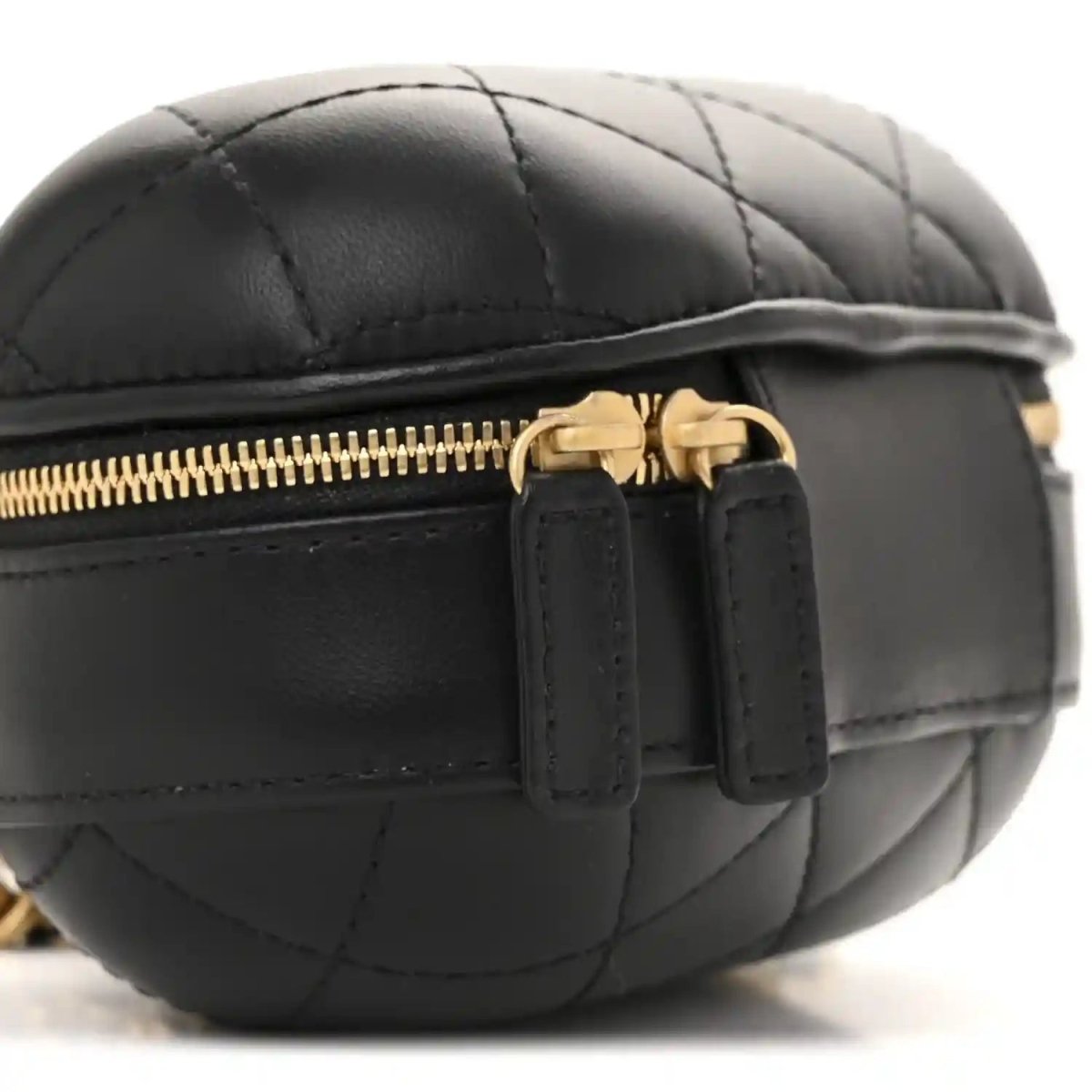 Black quilted vanity case side with gold zipper and leather pull tabs
