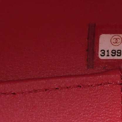 Red-lined interior panel with small Chanel logo tag and marking “3199”