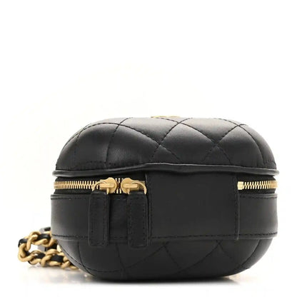 Black quilted vanity case with gold top zipper and gold chain strap