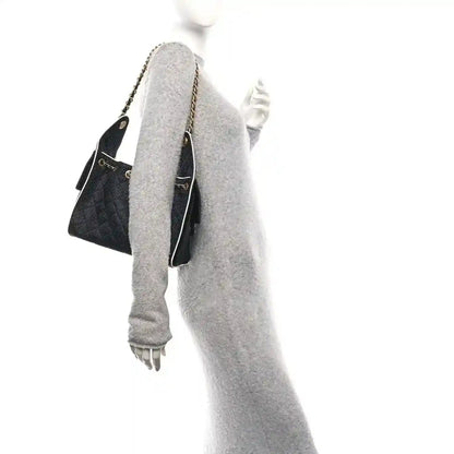 Chanel small handbag, black textured body with chain strap and pale lining