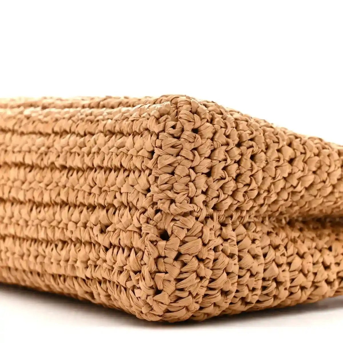 Dark beige braided raffia flap bag corner with tightly woven crochet texture