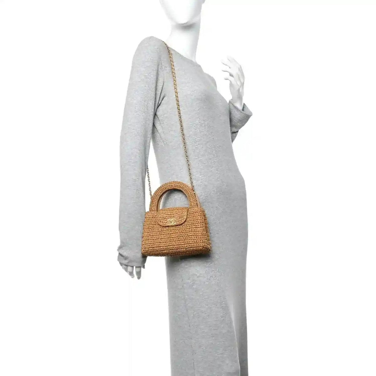 Dark beige braided raffia mini bag on chain strap, worn at side