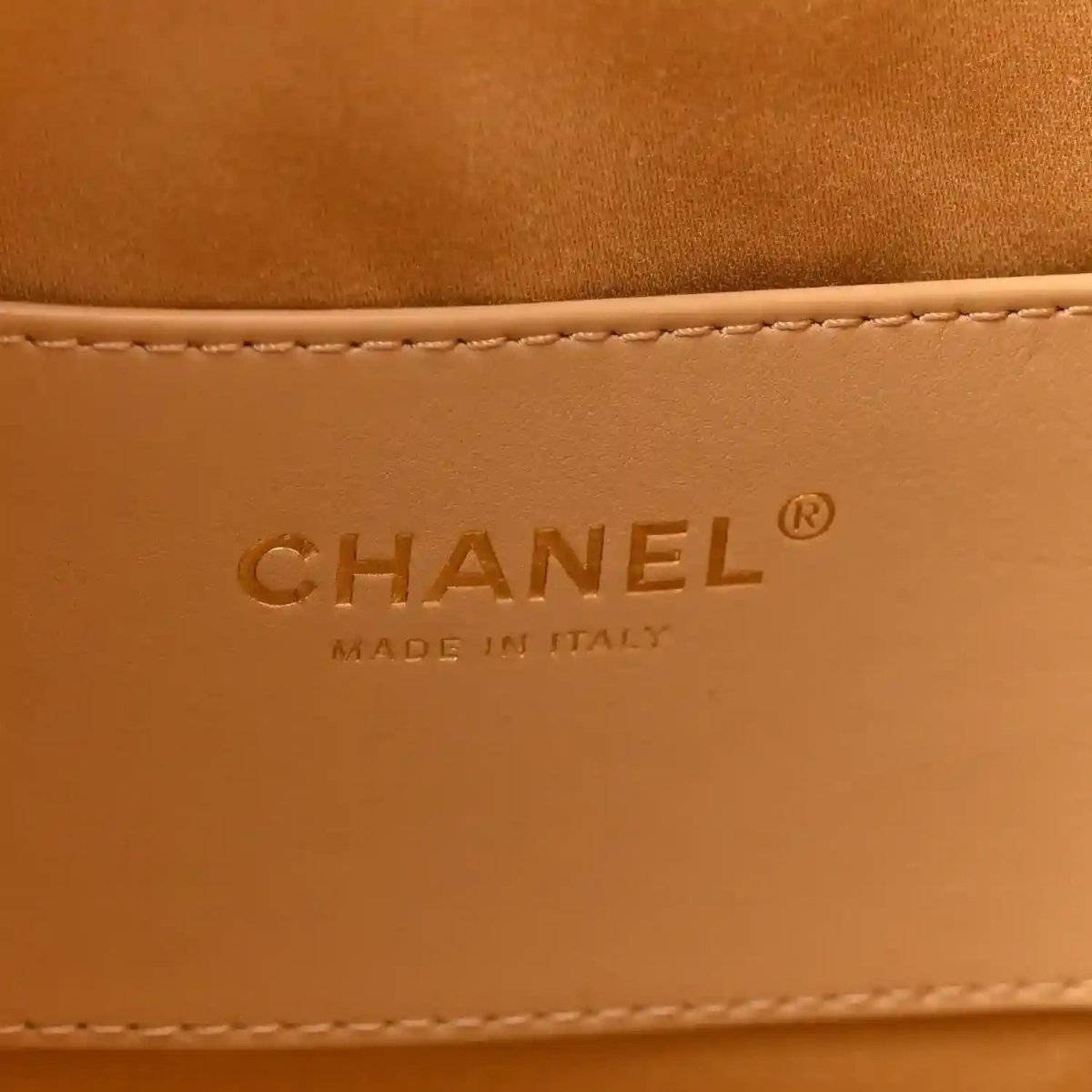 Chanel logo and “Made in Italy” embossed on tan leather lining