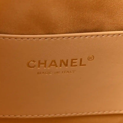 Chanel logo and “Made in Italy” embossed on tan leather lining