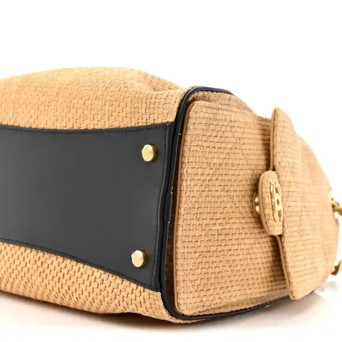 Beige raffia small handbag end with black trim band and two gold snap studs