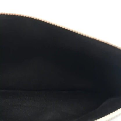 Close-up of handbag interior edge with gold-tone chain trim