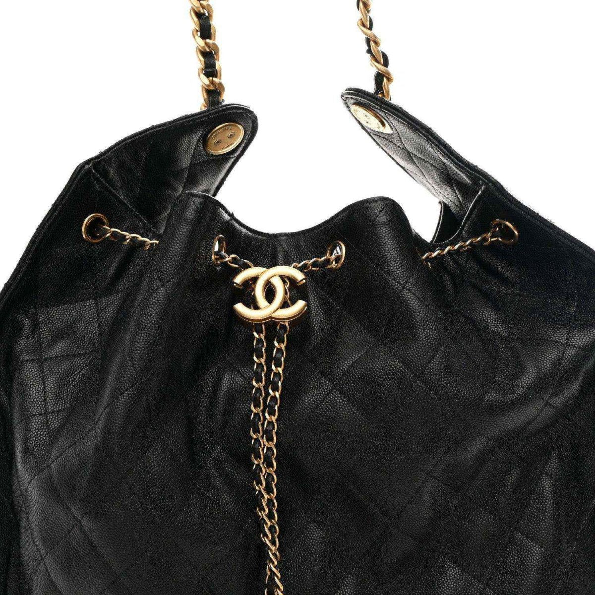 Top view of black quilted handbag with CC logo and gold-tone chain hardware