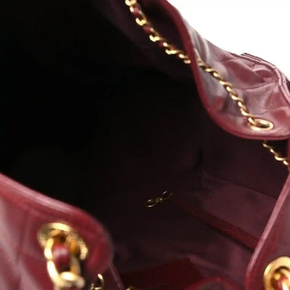 Burgundy leather Chanel bag interior with chain strap and gold-tone hardware