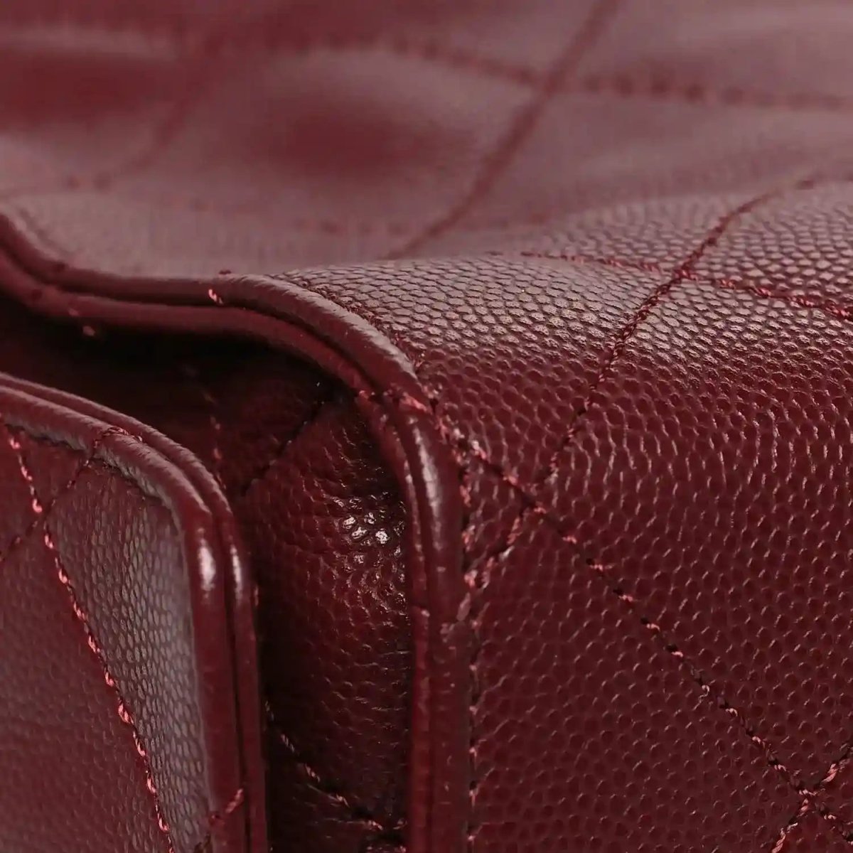 Burgundy caviar quilted flap bag with stitched leather handle and side panel detail