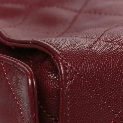Burgundy caviar quilted flap bag with stitched leather handle and side panel detail