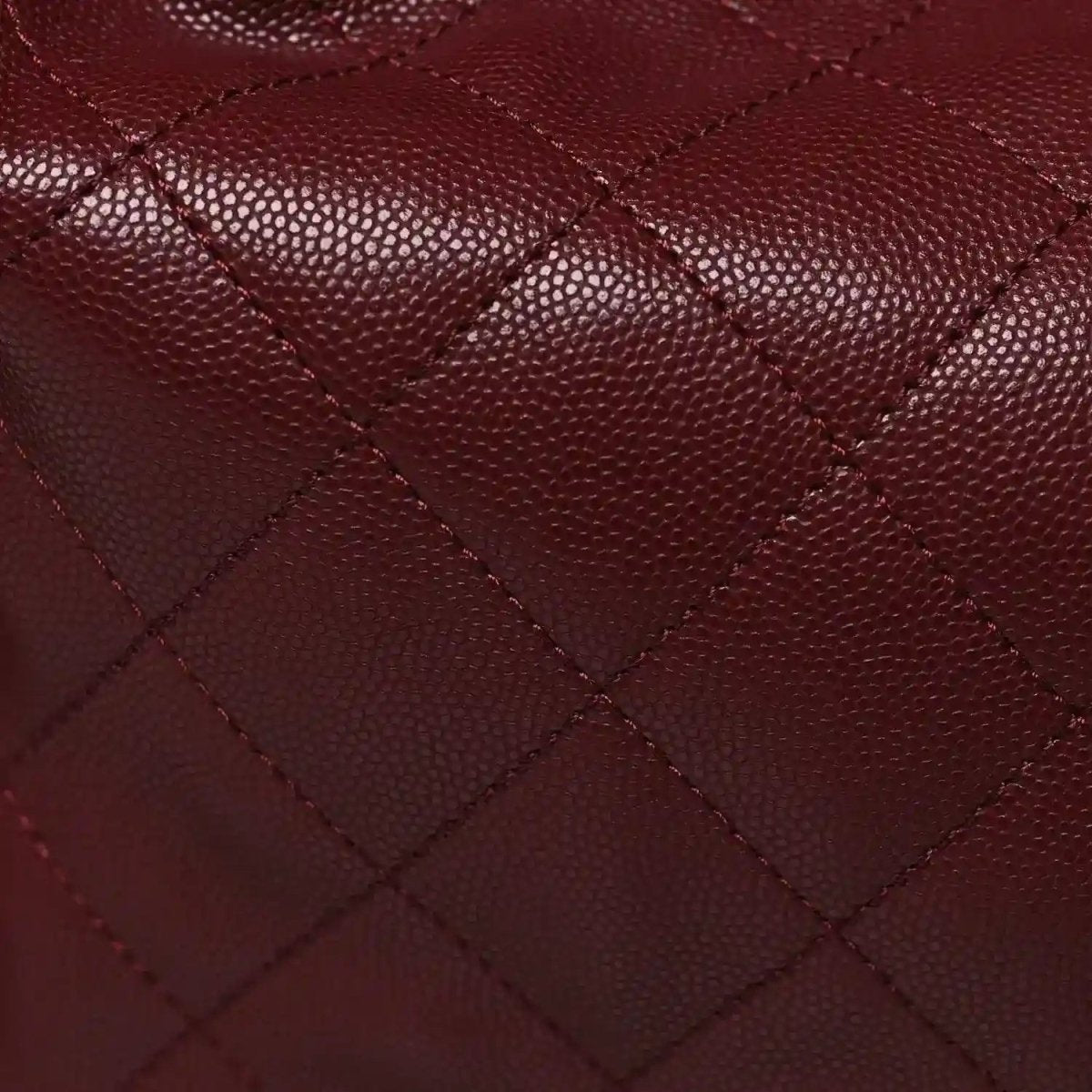 Burgundy caviar quilted leather with diamond stitching texture