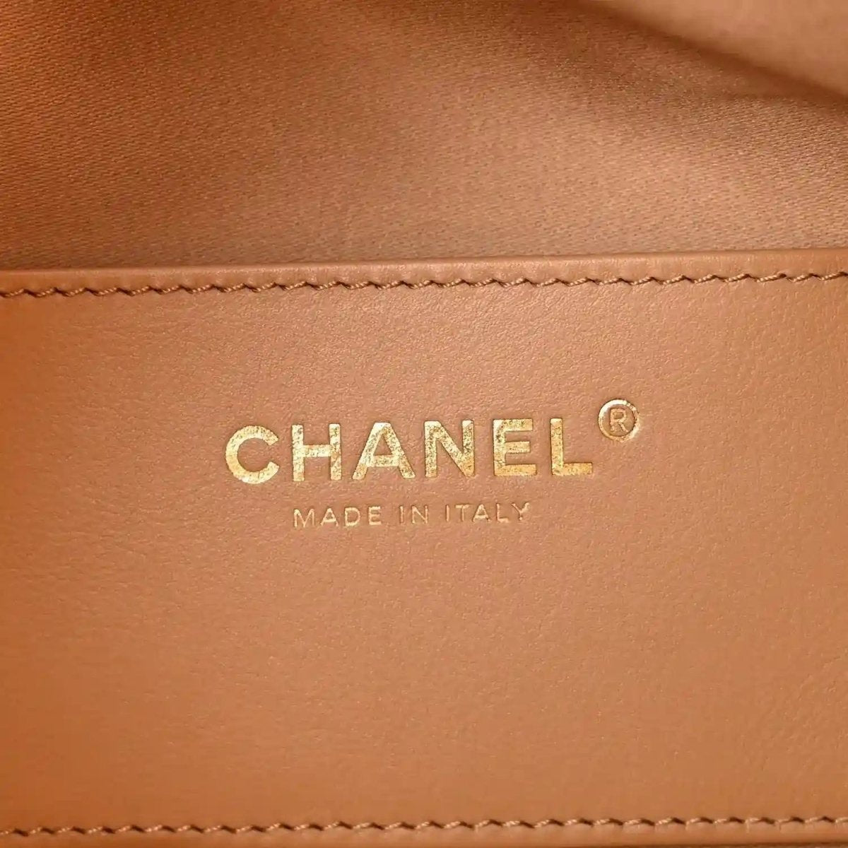 Beige leather handbag logo patch with “CHANEL” and “MADE IN ITALY”