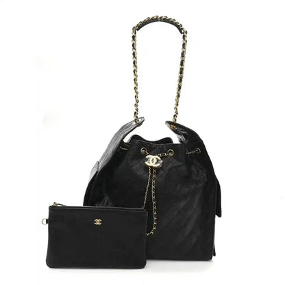 Black caviar quilted medium flap handbag with chain top handle and front emblem