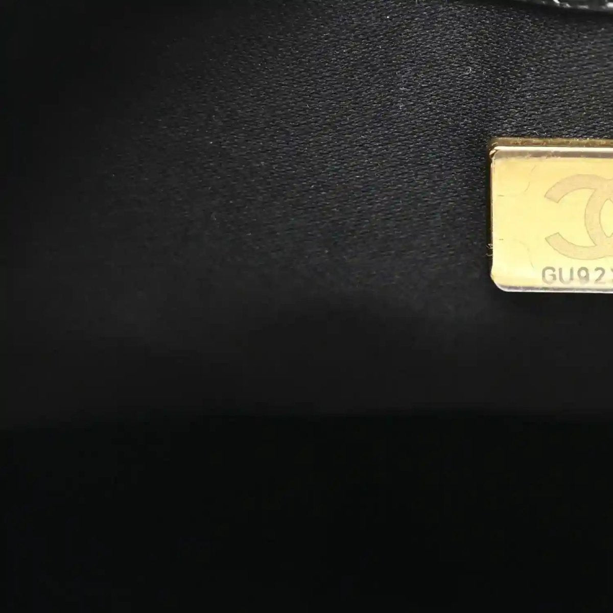 Black handbag label patch with gold embossed code